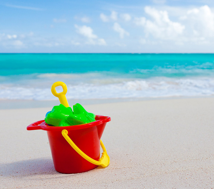 bucket and toys on the beach
