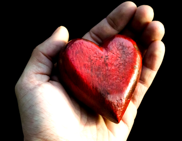Hand holding a red heart