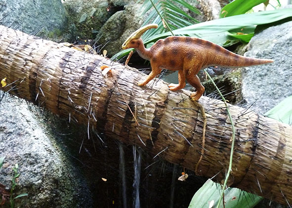 Dinosaur passing water fall